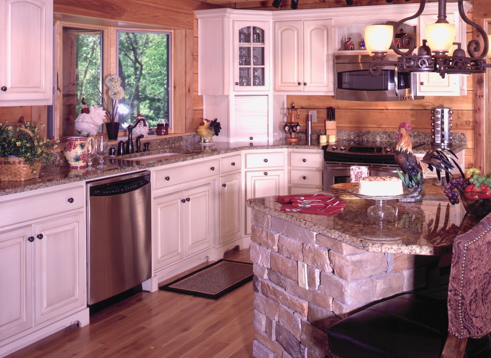 Example of a mid-sized mountain style l-shaped light wood floor kitchen design in Louisville with an undermount sink, recessed-panel cabinets, white cabinets, granite countertops, beige backsplash, stone slab backsplash, stainless steel appliances and an island