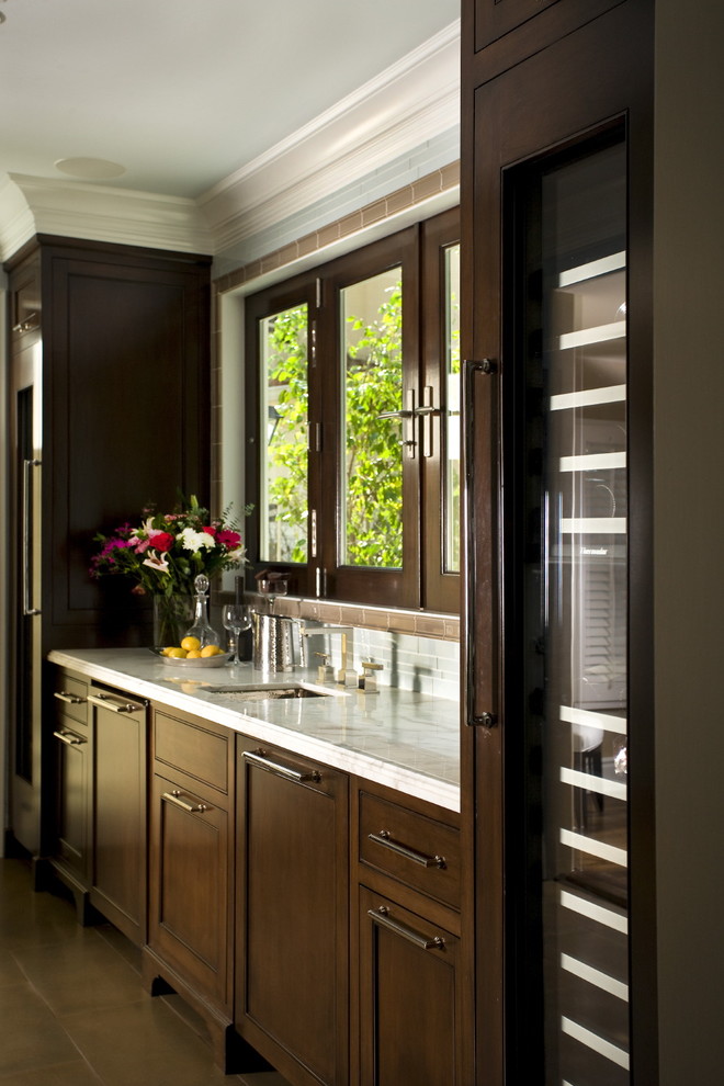 На фото: кухня в классическом стиле с фасадами с утопленной филенкой и темными деревянными фасадами с