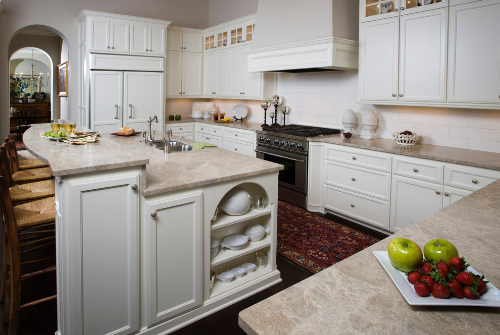 Example of a classic eat-in kitchen design in Austin with a double-bowl sink, marble countertops, an island, white cabinets, white backsplash, subway tile backsplash and stainless steel appliances