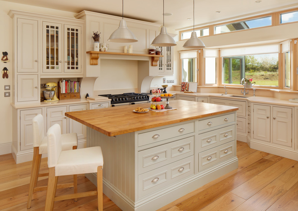 Стильный дизайн: кухня в классическом стиле с деревянной столешницей, барной стойкой, окном и эркером - последний тренд