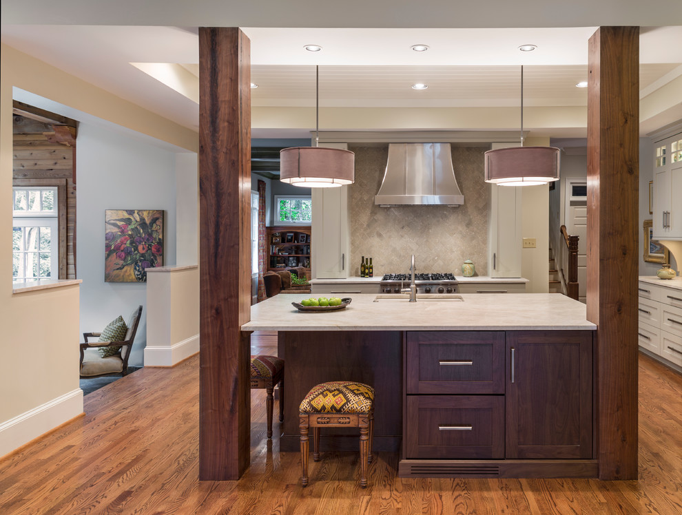 Eat-in kitchen - mid-sized traditional l-shaped dark wood floor and brown floor eat-in kitchen idea in Charlotte with a single-bowl sink, shaker cabinets, dark wood cabinets, beige backsplash, stone tile backsplash, stainless steel appliances and an island