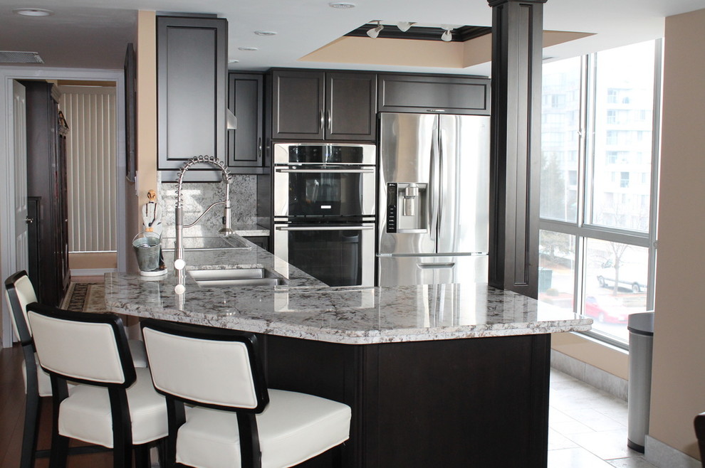 Inspiration for a medium sized contemporary u-shaped enclosed kitchen in Toronto with a double-bowl sink, recessed-panel cabinets, dark wood cabinets, granite worktops, grey splashback, stone slab splashback, stainless steel appliances, porcelain flooring, a breakfast bar, white floors and grey worktops.