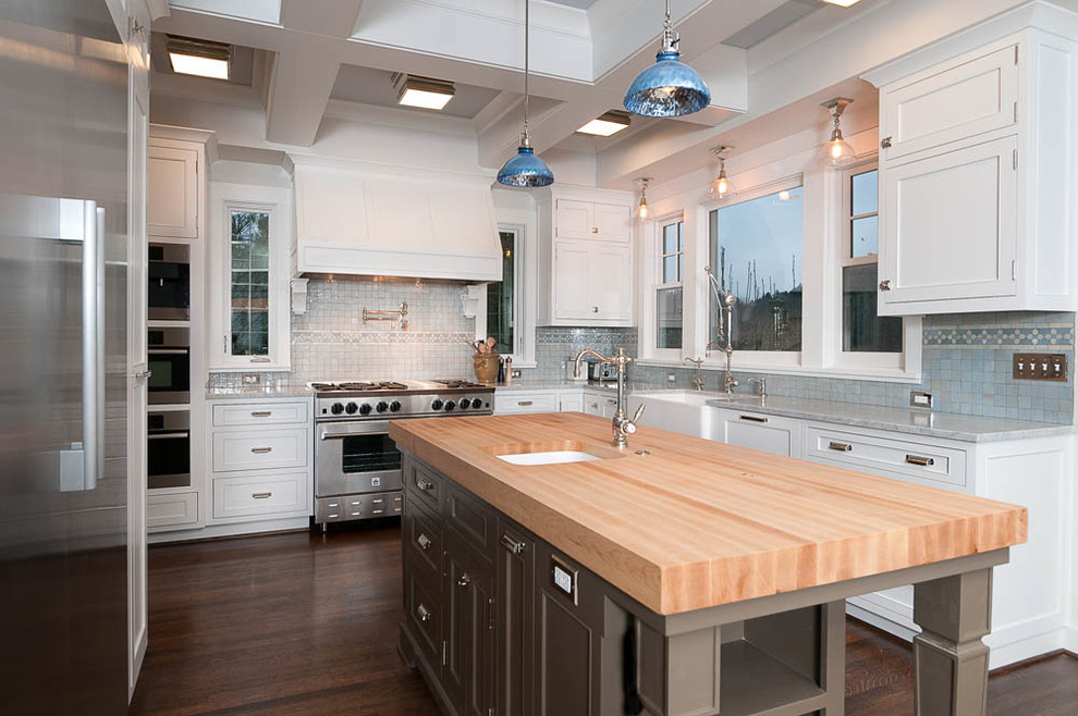 Example of a large transitional u-shaped dark wood floor eat-in kitchen design in Portland with a farmhouse sink, shaker cabinets, white cabinets, marble countertops, mosaic tile backsplash, stainless steel appliances, an island and blue backsplash