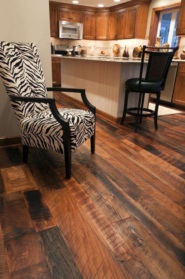 Example of a classic l-shaped medium tone wood floor eat-in kitchen design in Cleveland with recessed-panel cabinets, medium tone wood cabinets, beige backsplash, stainless steel appliances and an island
