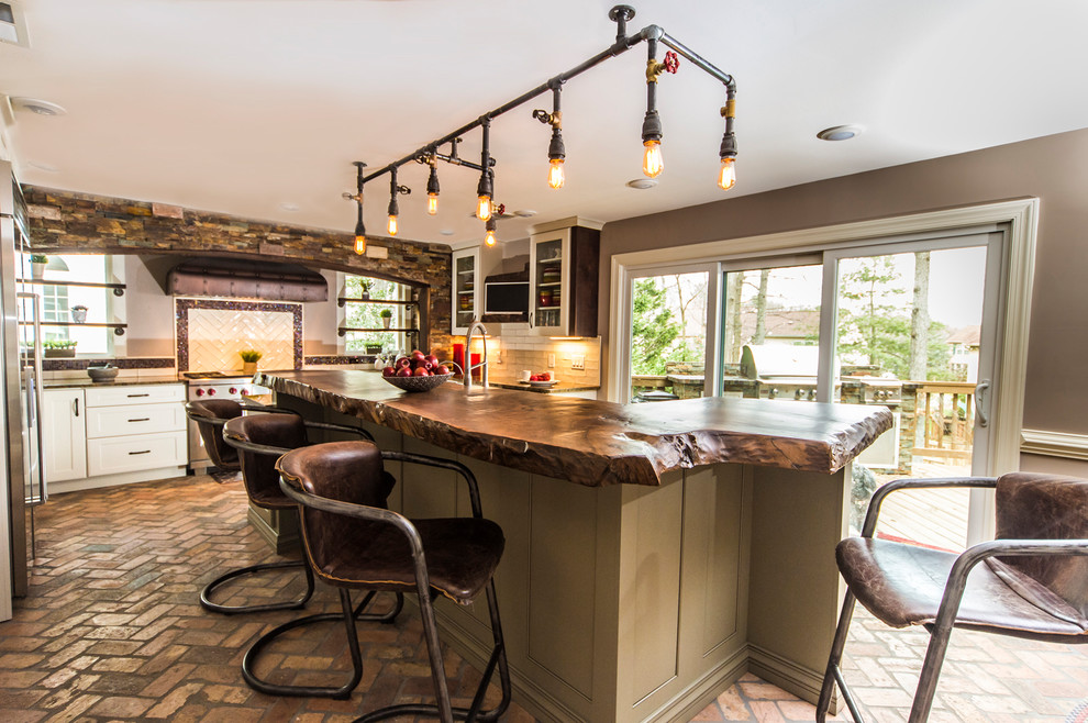Example of a small farmhouse u-shaped brick floor open concept kitchen design in DC Metro with a farmhouse sink, raised-panel cabinets, white cabinets, granite countertops, white backsplash, subway tile backsplash, stainless steel appliances and an island