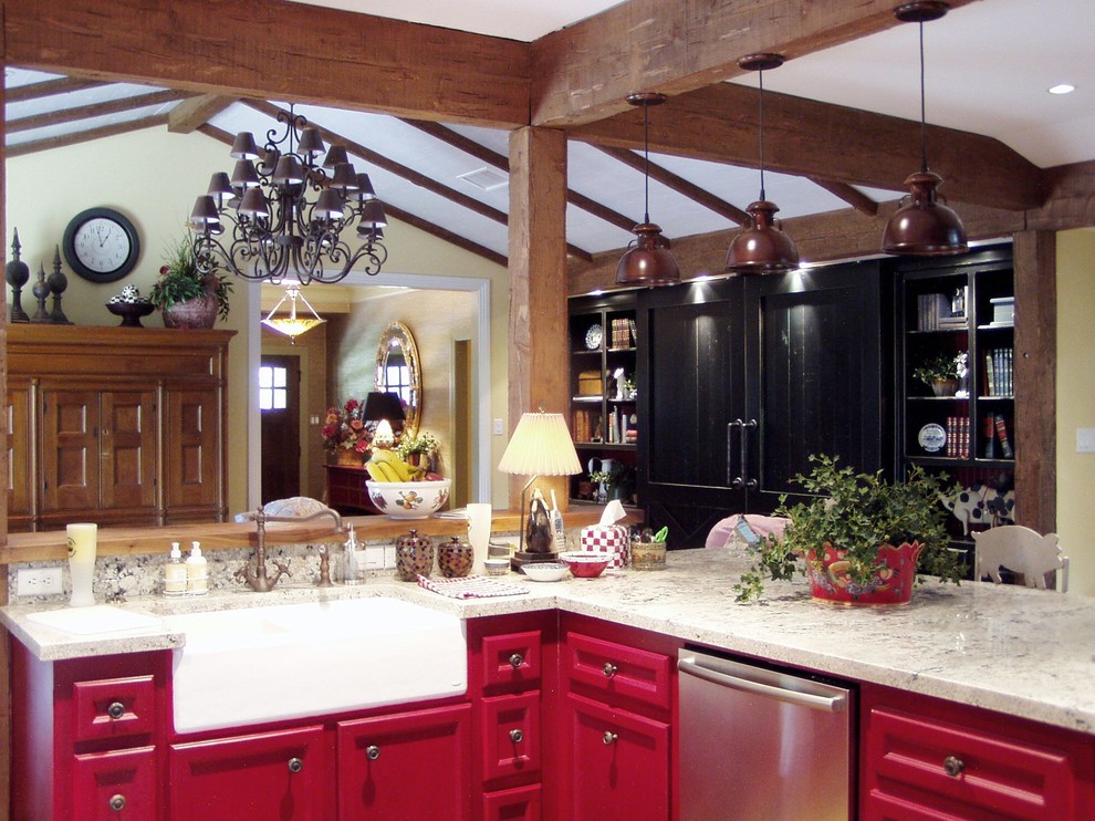 Inspiration for a mid-sized cottage u-shaped medium tone wood floor and brown floor open concept kitchen remodel in Houston with a farmhouse sink, recessed-panel cabinets, red cabinets, marble countertops, beige backsplash, stone slab backsplash and stainless steel appliances