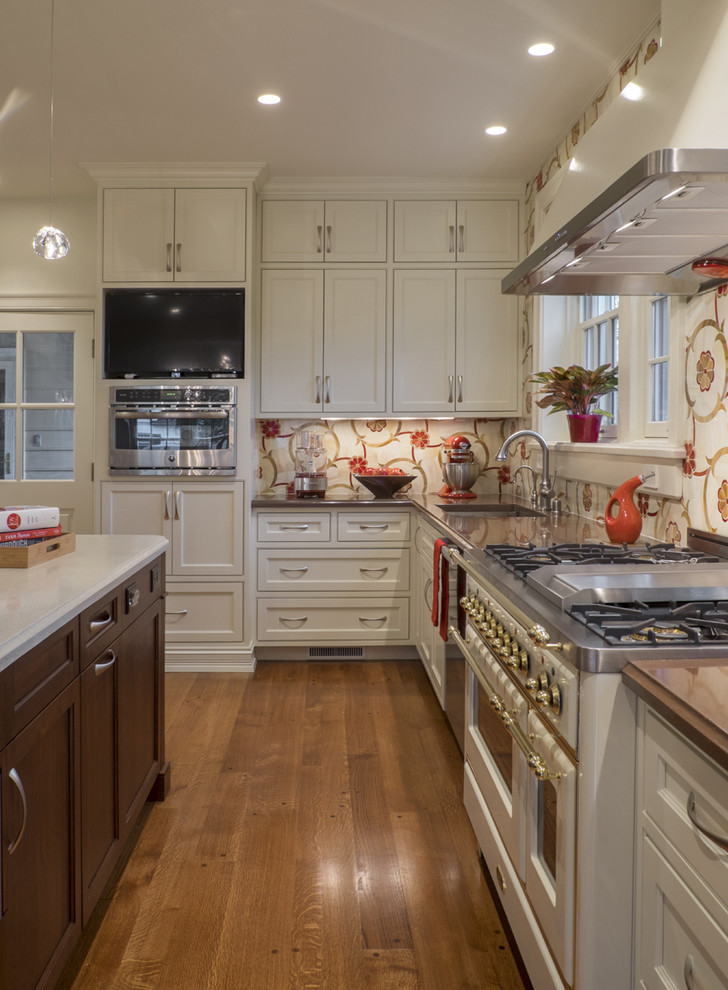 Inspiration for a huge timeless l-shaped medium tone wood floor enclosed kitchen remodel in Louisville with beaded inset cabinets, an island, a single-bowl sink, concrete countertops, red backsplash, mosaic tile backsplash and colored appliances