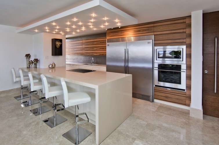 Eat-in kitchen - mid-sized craftsman galley marble floor eat-in kitchen idea in Miami with a double-bowl sink, flat-panel cabinets, medium tone wood cabinets, quartz countertops, gray backsplash, ceramic backsplash, stainless steel appliances and a peninsula