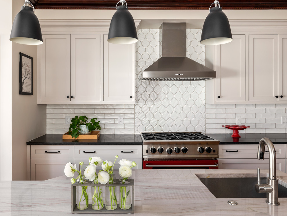 Inspiration for a large transitional medium tone wood floor and brown floor kitchen remodel in Boston with yellow cabinets, ceramic backsplash and an island