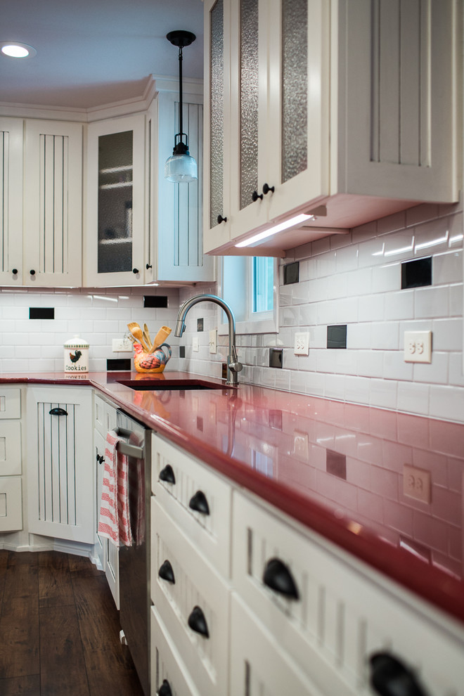 Photo of a medium sized farmhouse l-shaped kitchen/diner in Austin with a submerged sink, beaded cabinets, white cabinets, engineered stone countertops, multi-coloured splashback, metro tiled splashback, stainless steel appliances and an island.