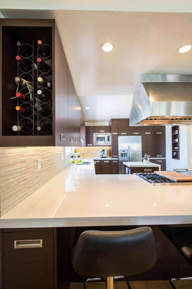 Eat-in kitchen - mid-sized modern u-shaped light wood floor eat-in kitchen idea in Los Angeles with a double-bowl sink, flat-panel cabinets, medium tone wood cabinets, quartz countertops, beige backsplash, stone tile backsplash, stainless steel appliances and an island