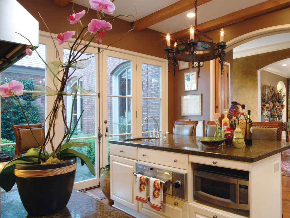 Bild på ett avskilt, mellanstort vintage l-kök, med en undermonterad diskho, luckor med upphöjd panel, vita skåp, granitbänkskiva, rostfria vitvaror, mellanmörkt trägolv och en köksö