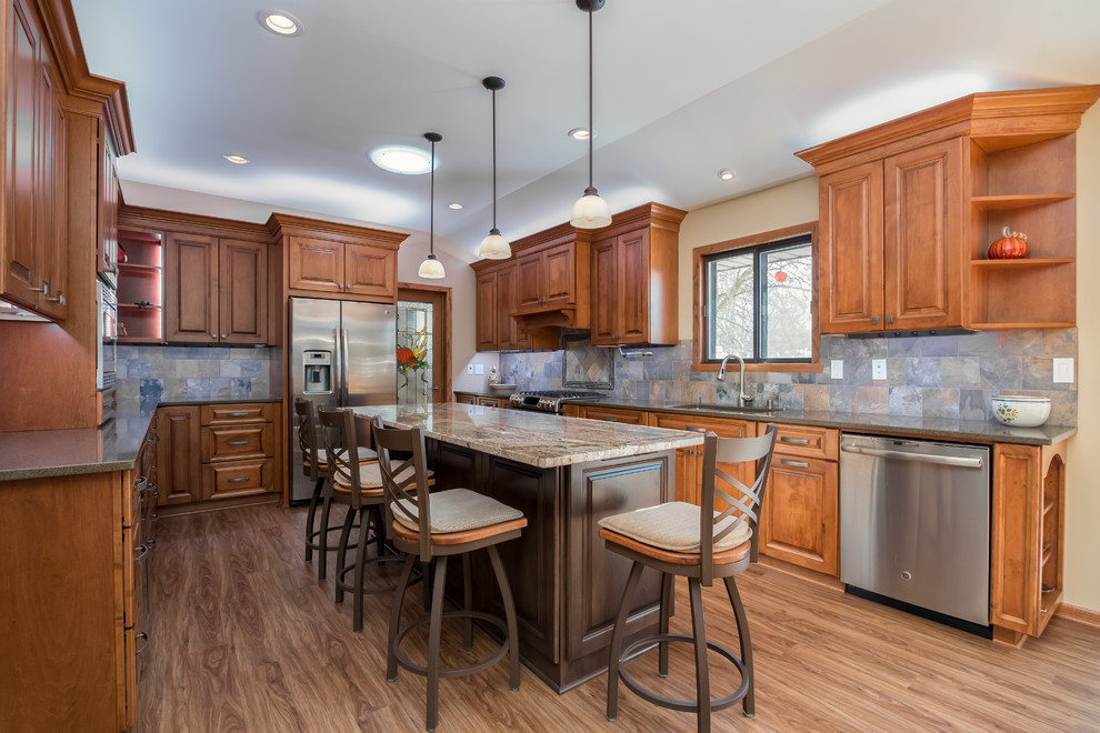 Large classic u-shaped kitchen/diner in Milwaukee with flat-panel cabinets, dark wood cabinets, quartz worktops and an island.