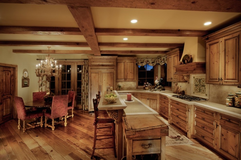 Design ideas for a large rustic u-shaped open plan kitchen in Denver with raised-panel cabinets, medium wood cabinets and multiple islands.