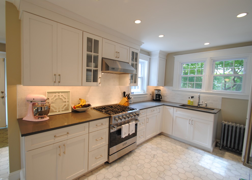 This is an example of a contemporary kitchen/diner in Philadelphia with shaker cabinets, white cabinets, engineered stone countertops, stainless steel appliances, marble flooring and no island.