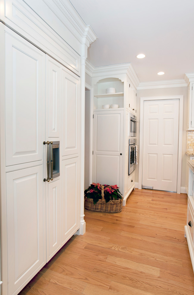 Inspiration for a timeless l-shaped open concept kitchen remodel in Bridgeport with raised-panel cabinets, white cabinets and paneled appliances