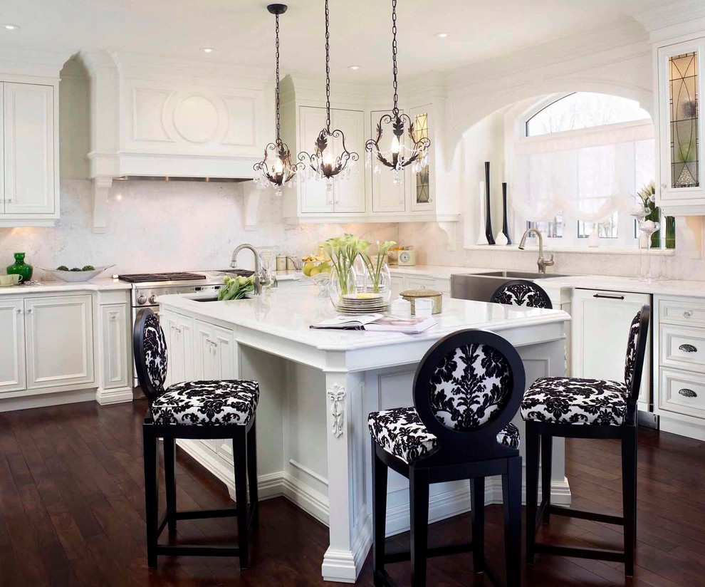 Inspiration for a mid-sized timeless l-shaped dark wood floor eat-in kitchen remodel in Toronto with recessed-panel cabinets, white cabinets, paneled appliances, a farmhouse sink, quartz countertops, white backsplash, stone slab backsplash and an island