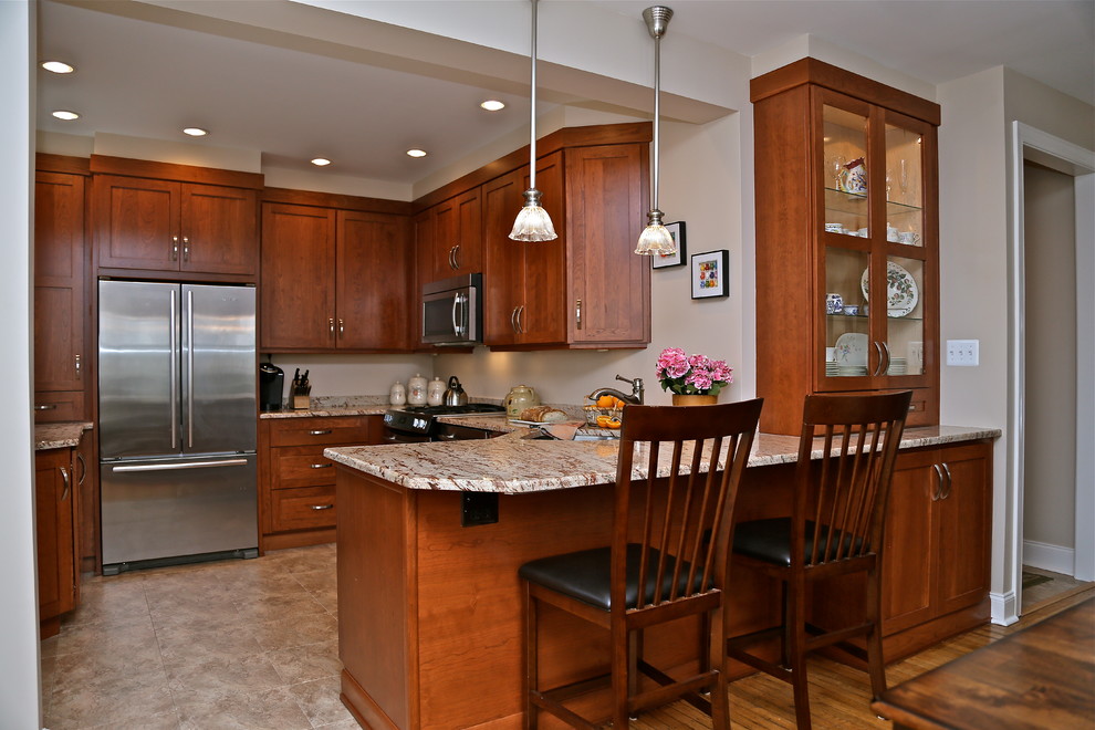 Example of a mid-sized classic medium tone wood floor eat-in kitchen design in Philadelphia with an undermount sink, recessed-panel cabinets, medium tone wood cabinets, granite countertops, multicolored backsplash, stainless steel appliances and no island