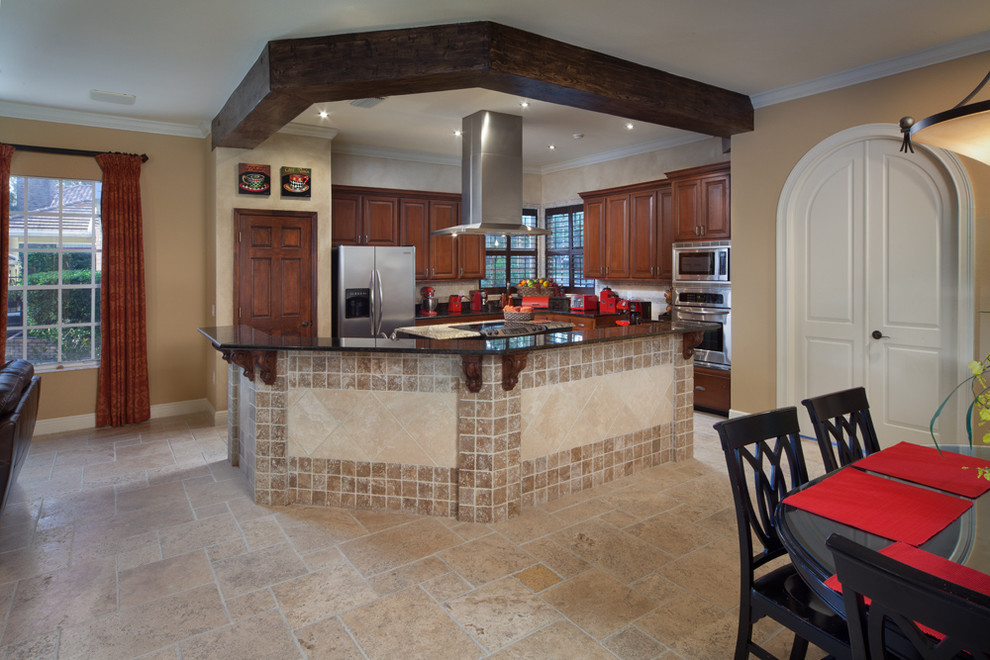 Mid-sized tuscan u-shaped travertine floor open concept kitchen photo in Orlando with a drop-in sink, raised-panel cabinets, medium tone wood cabinets, granite countertops, beige backsplash, stone tile backsplash, stainless steel appliances and an island