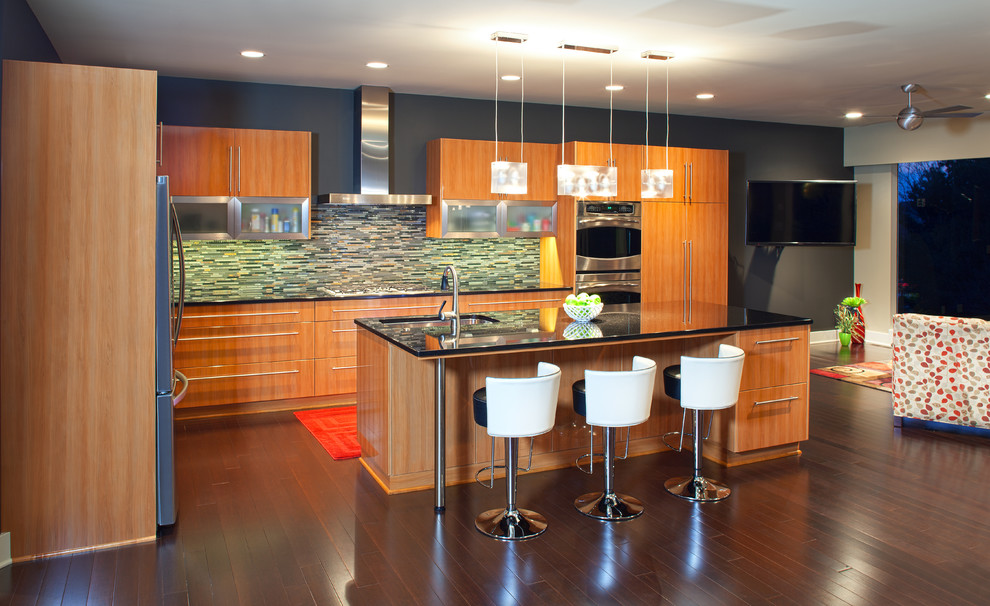 Trendy l-shaped open concept kitchen photo in Omaha with flat-panel cabinets, medium tone wood cabinets and multicolored backsplash