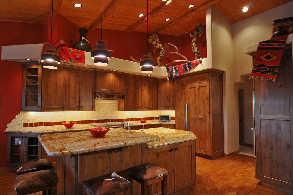 Inspiration for a mid-sized rustic l-shaped light wood floor eat-in kitchen remodel in Phoenix with a double-bowl sink, recessed-panel cabinets, light wood cabinets, granite countertops, beige backsplash, stone tile backsplash, stainless steel appliances and an island