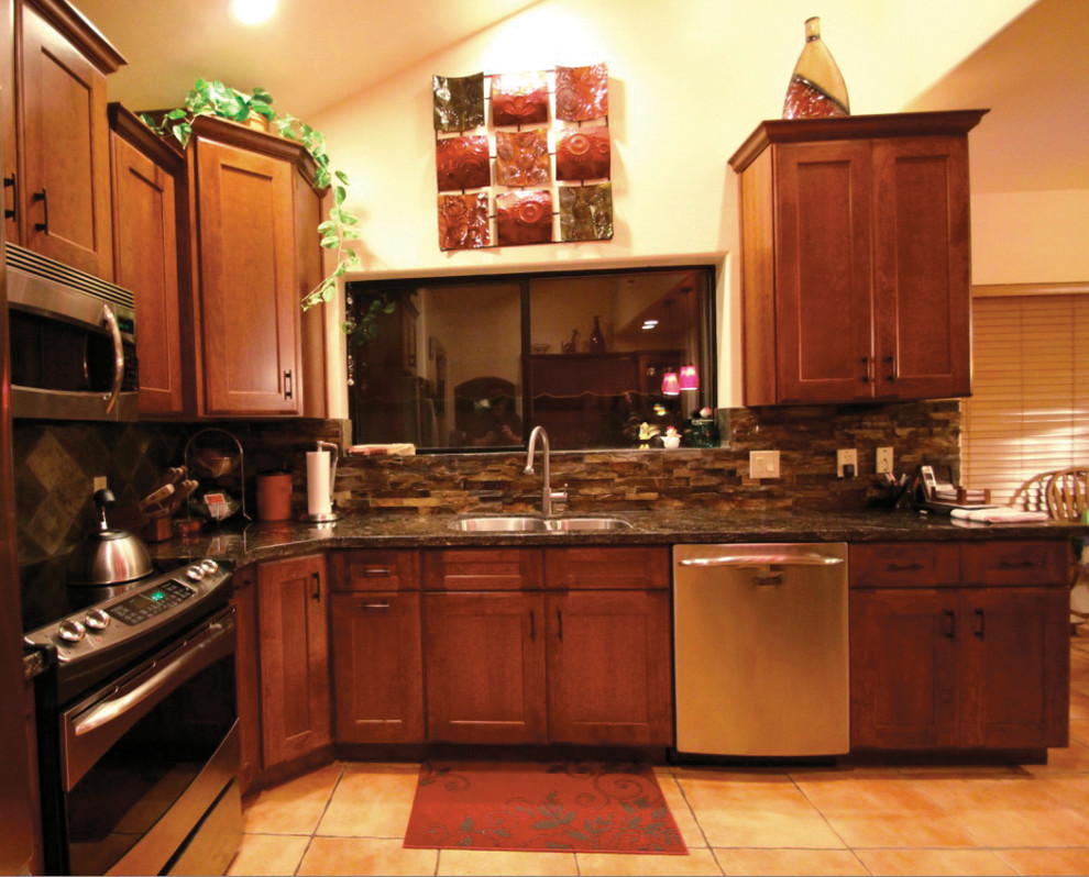 Mid-sized transitional l-shaped ceramic tile kitchen photo in Phoenix with a double-bowl sink, recessed-panel cabinets, medium tone wood cabinets, granite countertops, multicolored backsplash, stone tile backsplash, stainless steel appliances and an island