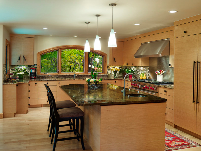 Inspiration for a large craftsman u-shaped light wood floor kitchen remodel in Cleveland with a double-bowl sink, flat-panel cabinets, light wood cabinets, granite countertops, brown backsplash, ceramic backsplash, stainless steel appliances and an island
