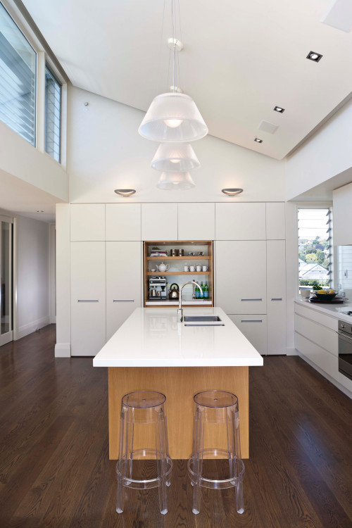 Stylish Contrast: White Cabinetry with a Wood Central Island and Acrylic Stools