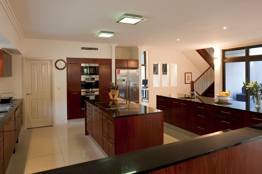 Design ideas for an expansive classic u-shaped enclosed kitchen in Brisbane with a double-bowl sink, shaker cabinets, dark wood cabinets, granite worktops, stainless steel appliances, porcelain flooring and multiple islands.