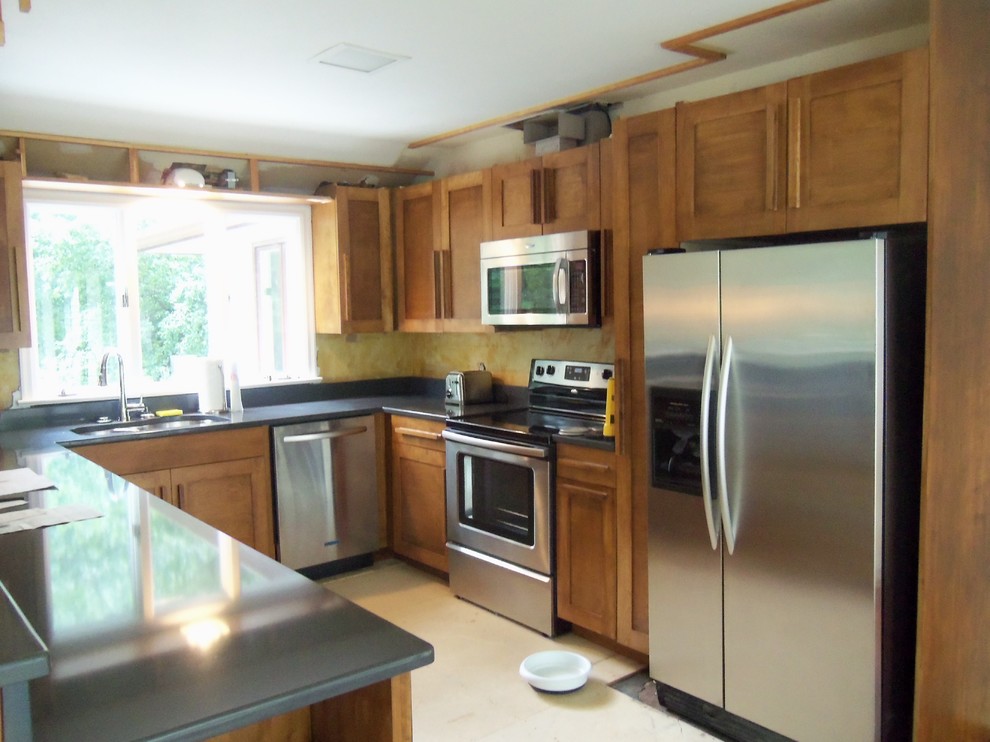 Example of a mid-sized u-shaped ceramic tile eat-in kitchen design in Newark with a double-bowl sink, shaker cabinets, medium tone wood cabinets, quartz countertops, gray backsplash, glass tile backsplash, stainless steel appliances and two islands