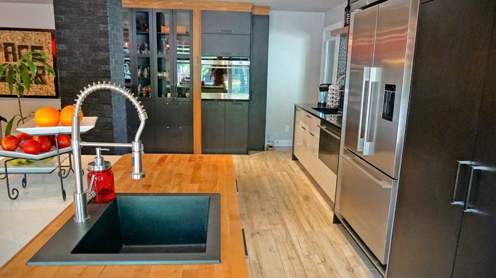 Moderne Wohnküche mit Triple-Waschtisch, Quarzit-Arbeitsplatte, Küchenrückwand in Schwarz, Rückwand aus Mosaikfliesen, Küchengeräten aus Edelstahl und Keramikboden in Montreal