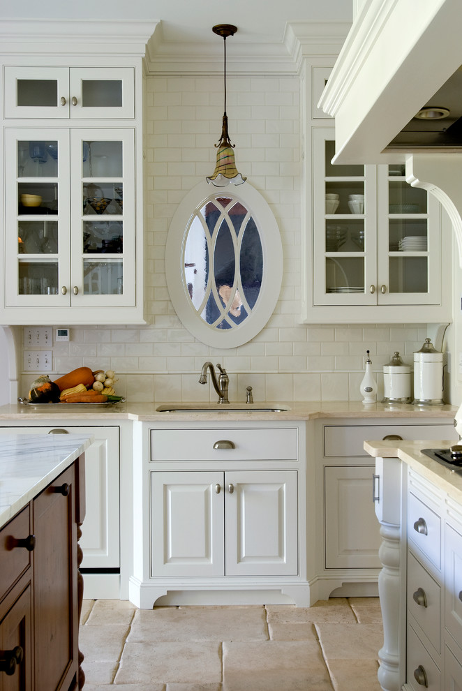 Elegant kitchen photo in DC Metro with an undermount sink, raised-panel cabinets, white cabinets, white backsplash and subway tile backsplash