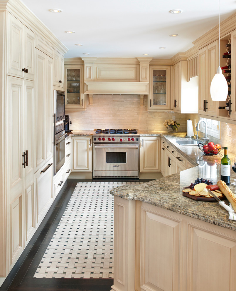 Immagine di una cucina chic di medie dimensioni con ante con bugna sagomata, ante beige, top in granito, paraspruzzi beige, paraspruzzi in gres porcellanato e elettrodomestici in acciaio inossidabile