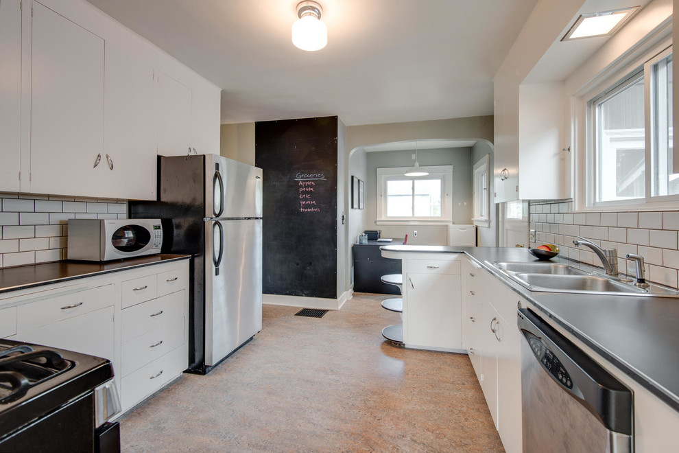 Example of a mid-century modern kitchen design in Portland