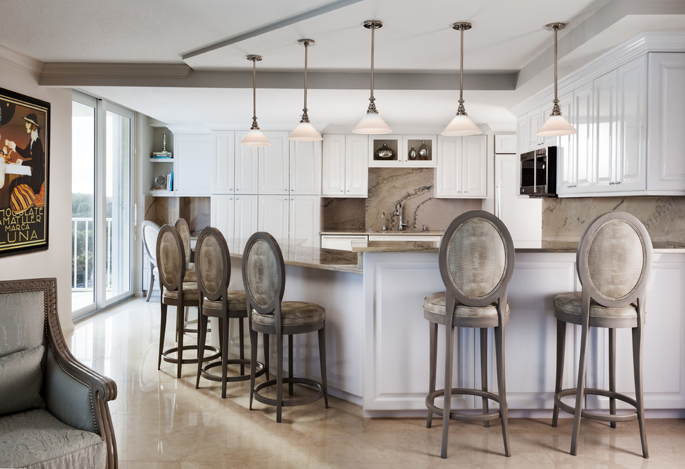 Transitional kitchen photo in Miami with raised-panel cabinets, white cabinets, beige backsplash and a peninsula