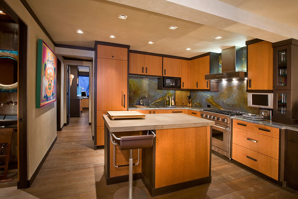 Inspiration for a medium sized modern l-shaped kitchen in Denver with a submerged sink, stone slab splashback, stainless steel appliances, medium hardwood flooring, brown floors, flat-panel cabinets, medium wood cabinets, granite worktops and an island.