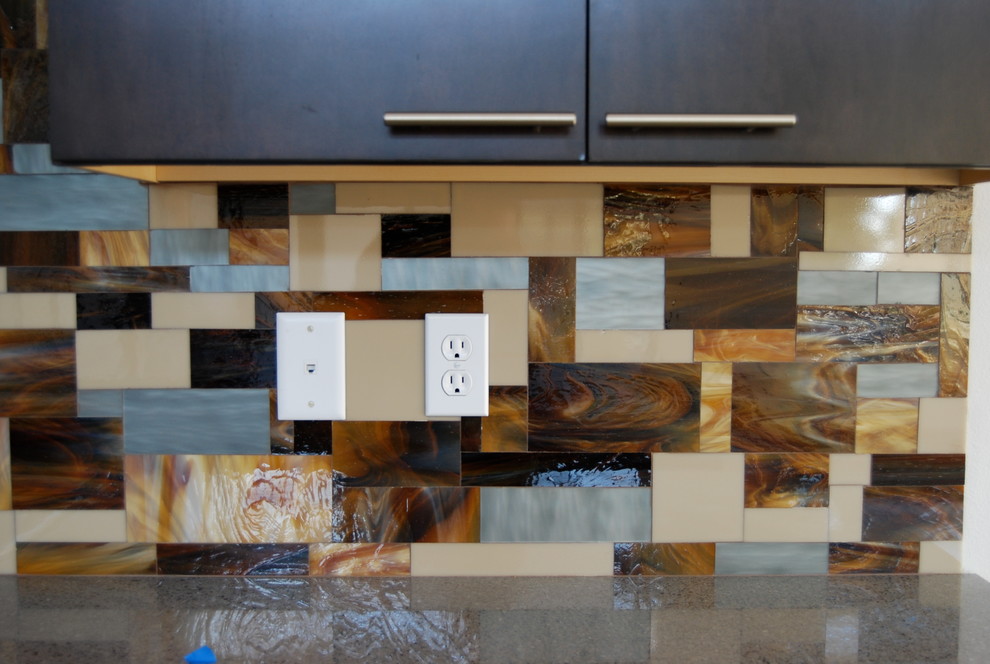 Example of a trendy kitchen design in Las Vegas with recycled glass countertops, multicolored backsplash and stainless steel appliances