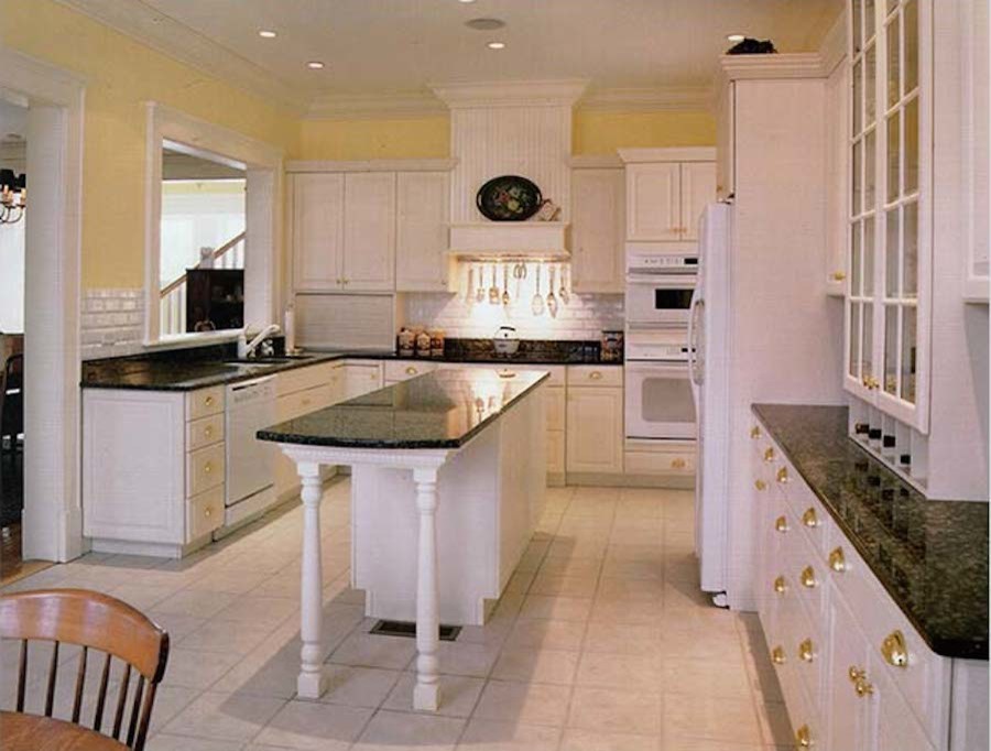 Inspiration for a galley ceramic tile kitchen remodel in Boston with recessed-panel cabinets, white cabinets, white appliances and an island