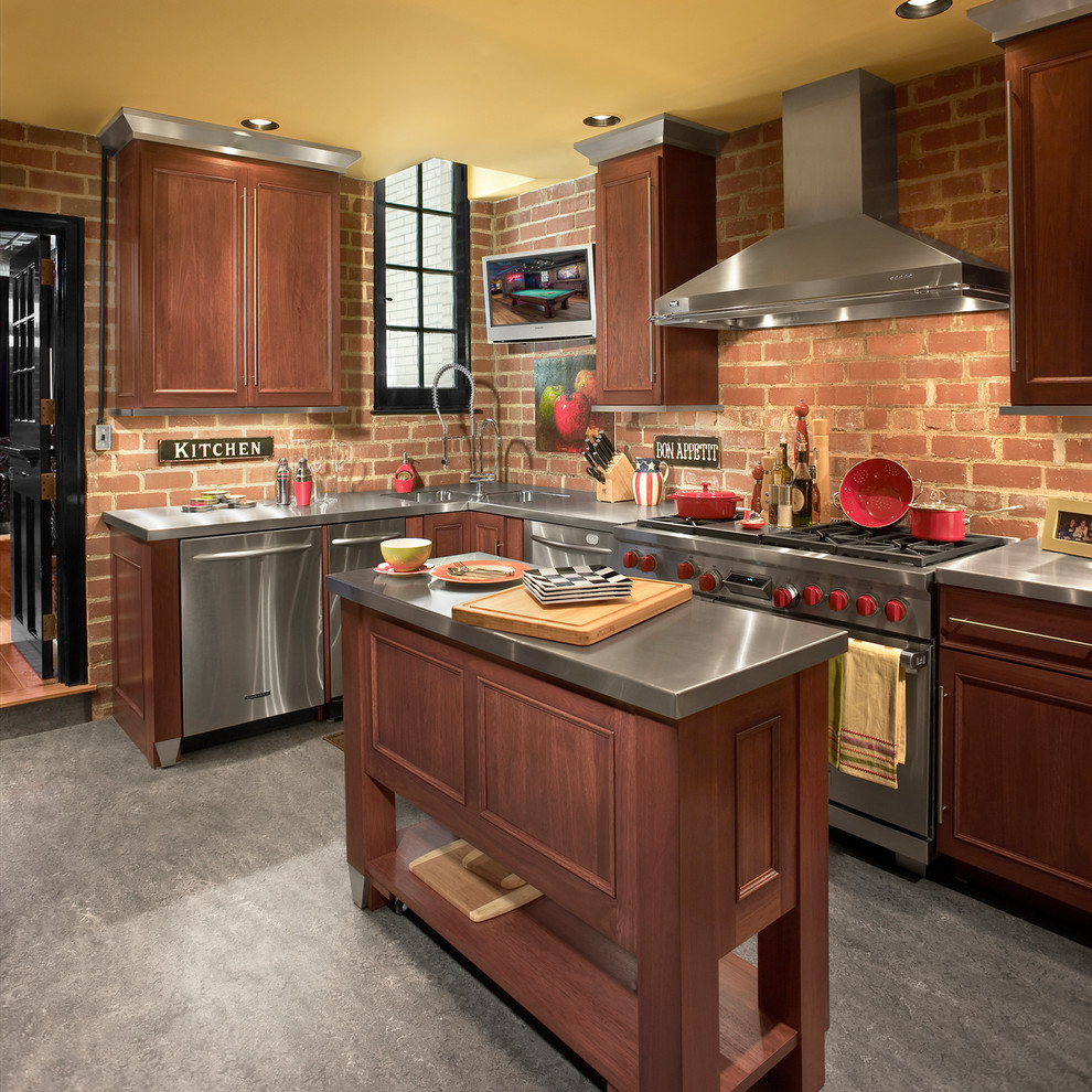 Small urban l-shaped concrete floor kitchen photo in Cleveland with an integrated sink, recessed-panel cabinets, dark wood cabinets, stainless steel countertops, red backsplash, stainless steel appliances and an island