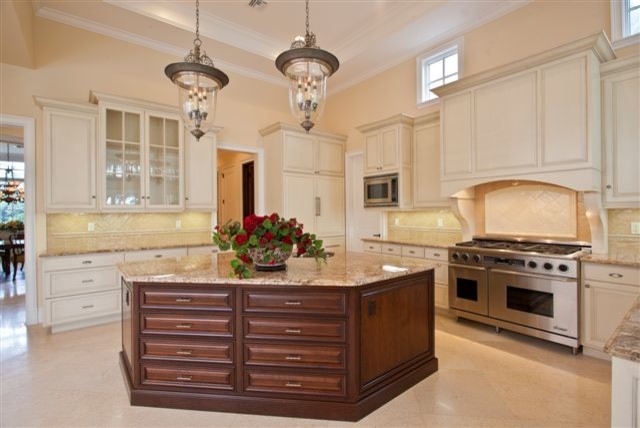 Example of a huge classic marble floor kitchen design in Miami with an undermount sink, raised-panel cabinets, granite countertops, stone slab backsplash, stainless steel appliances and an island