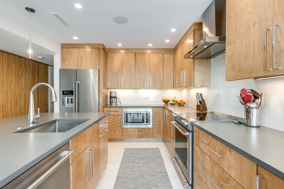 Example of a mid-sized trendy l-shaped ceramic tile and white floor eat-in kitchen design in DC Metro with an undermount sink, flat-panel cabinets, light wood cabinets, quartz countertops, white backsplash, ceramic backsplash, stainless steel appliances, an island and gray countertops