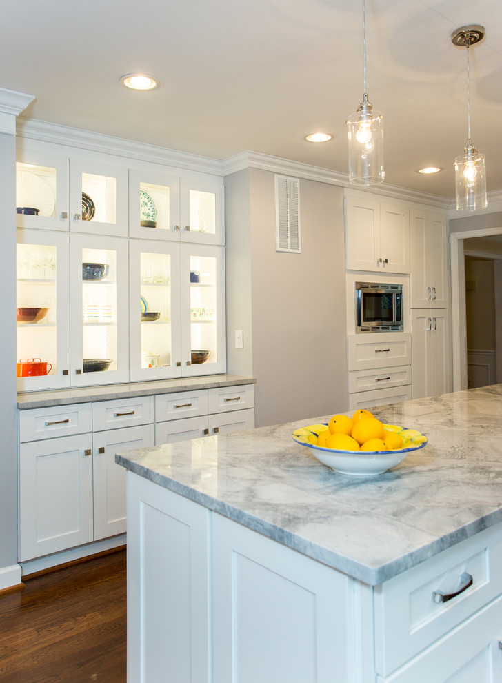 Large transitional l-shaped dark wood floor eat-in kitchen photo in DC Metro with an undermount sink, shaker cabinets, white cabinets, granite countertops, white backsplash, porcelain backsplash, stainless steel appliances and an island