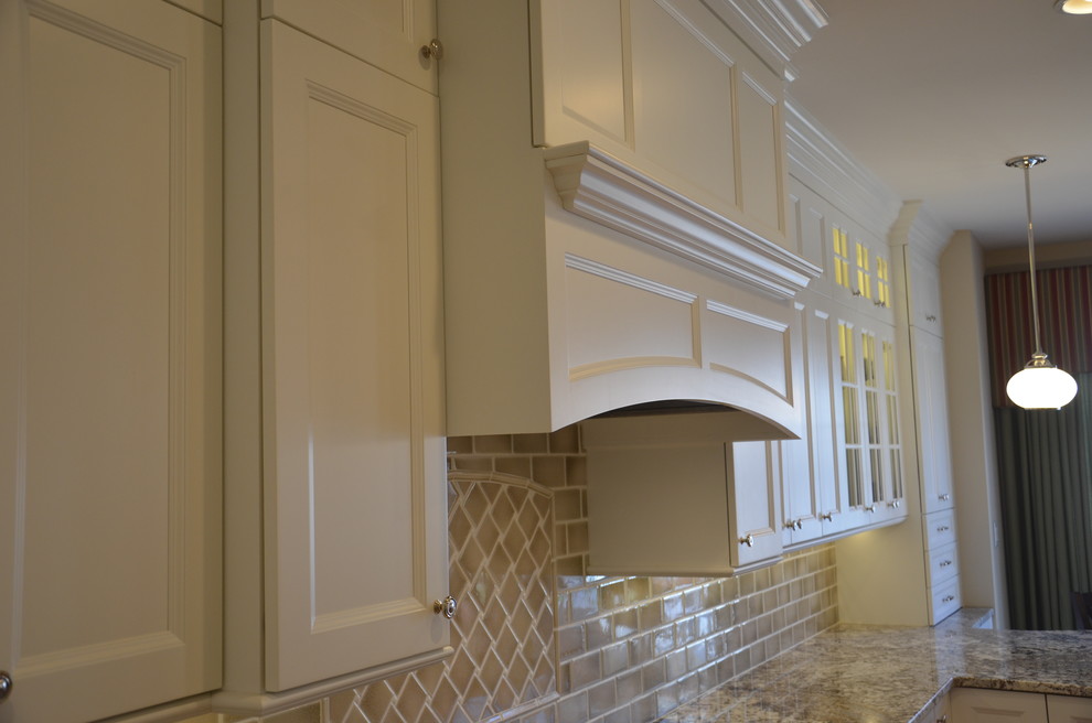 Large elegant l-shaped enclosed kitchen photo in DC Metro with recessed-panel cabinets, white cabinets and a peninsula