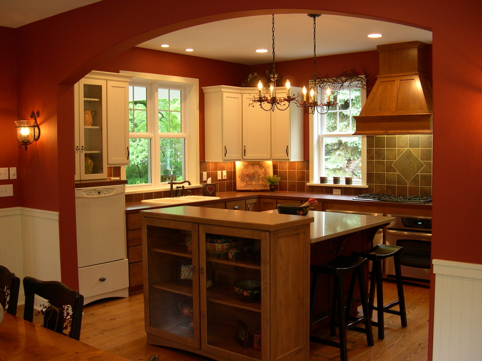 Eat-in kitchen - country u-shaped medium tone wood floor eat-in kitchen idea in Grand Rapids with a double-bowl sink and solid surface countertops