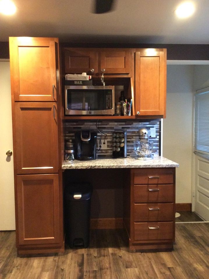 Example of a small classic u-shaped medium tone wood floor and brown floor enclosed kitchen design in Denver with a drop-in sink, granite countertops, multicolored backsplash, glass tile backsplash, black appliances, raised-panel cabinets and medium tone wood cabinets