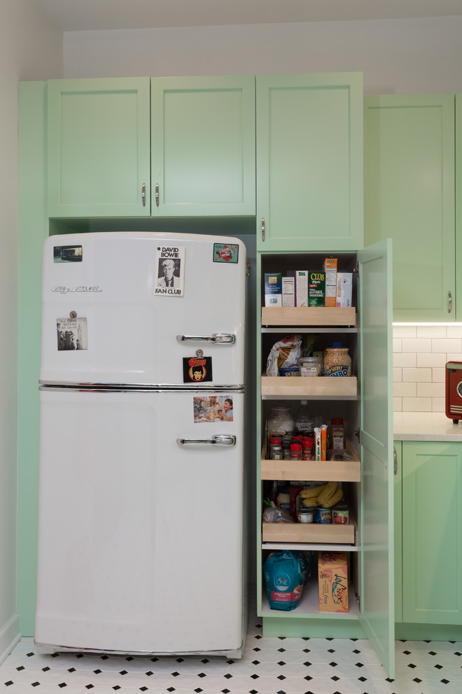 Mid-sized elegant l-shaped porcelain tile open concept kitchen photo in Chicago with a farmhouse sink, shaker cabinets, green cabinets, quartz countertops, white backsplash, subway tile backsplash, white appliances and a peninsula