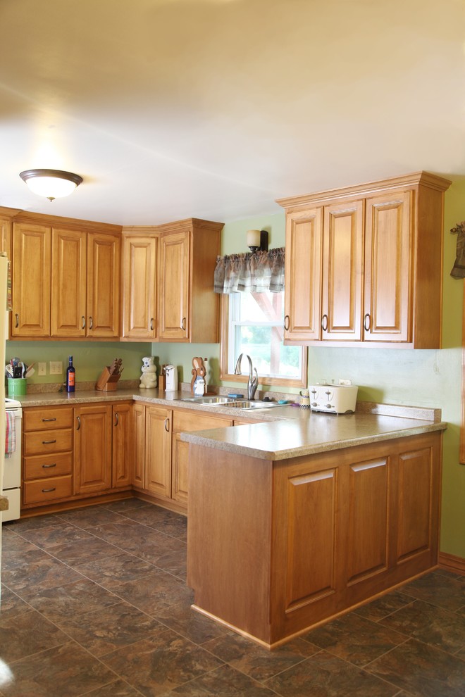 Medium sized traditional kitchen/diner in Other with a double-bowl sink, raised-panel cabinets, light wood cabinets, laminate countertops, white appliances, limestone flooring and a breakfast bar.