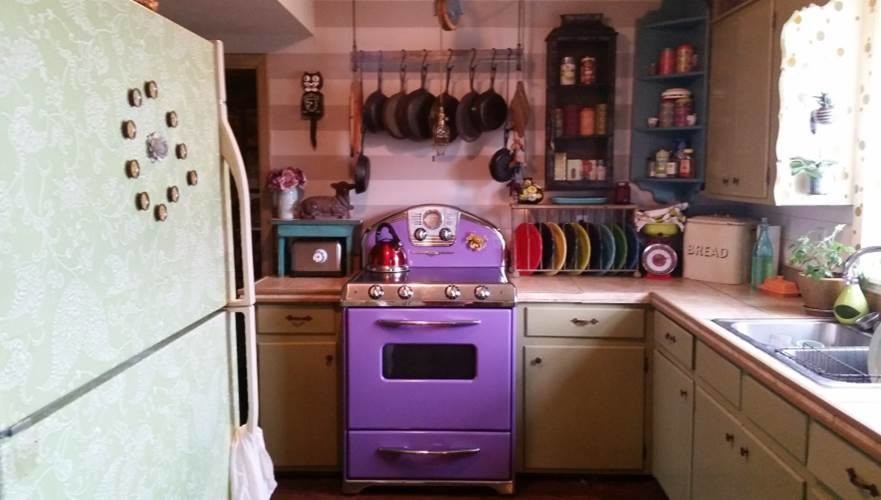 バンクーバーにある中くらいなエクレクティックスタイルのおしゃれなキッチン (ダブルシンク、ベージュキッチンパネル、カラー調理設備、アイランドなし) の写真