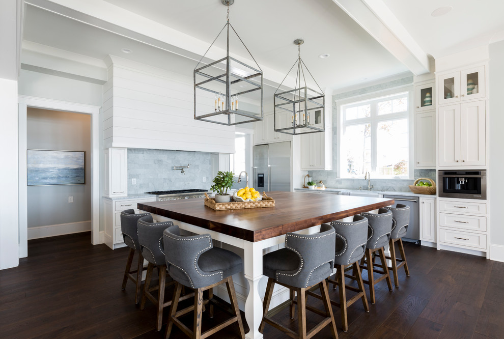 Beach style l-shaped kitchen in Charlotte with shaker cabinets, white cabinets, wood worktops, blue splashback, dark hardwood flooring, an island and brown floors.