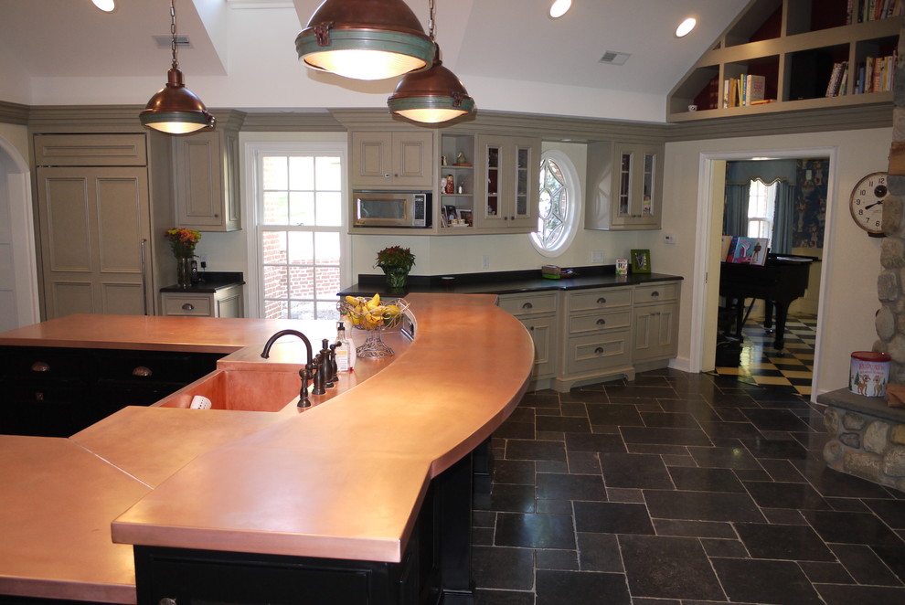 Large elegant l-shaped slate floor eat-in kitchen photo in Newark with an undermount sink, recessed-panel cabinets, beige cabinets, copper countertops, yellow backsplash, glass tile backsplash, stainless steel appliances and an island